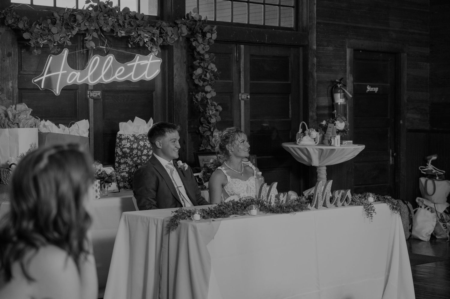 Black and white photo of wedding reception tables and decor.