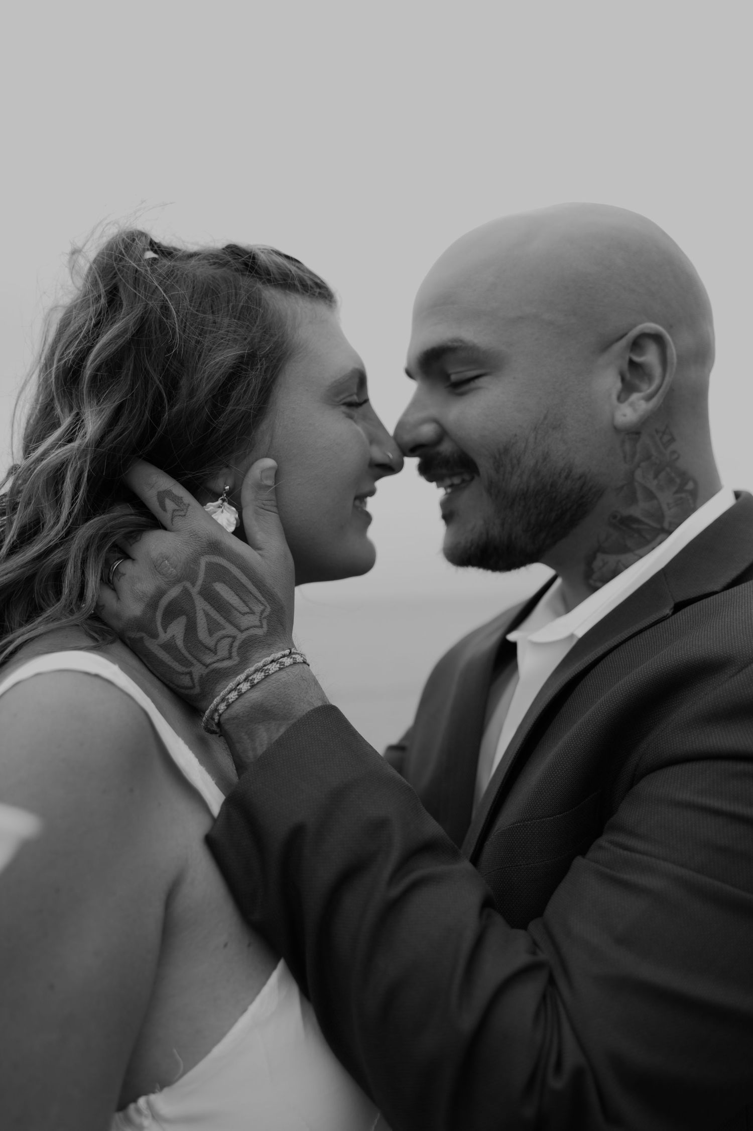 Intimate black and white portrait of a romantic moment between two people.