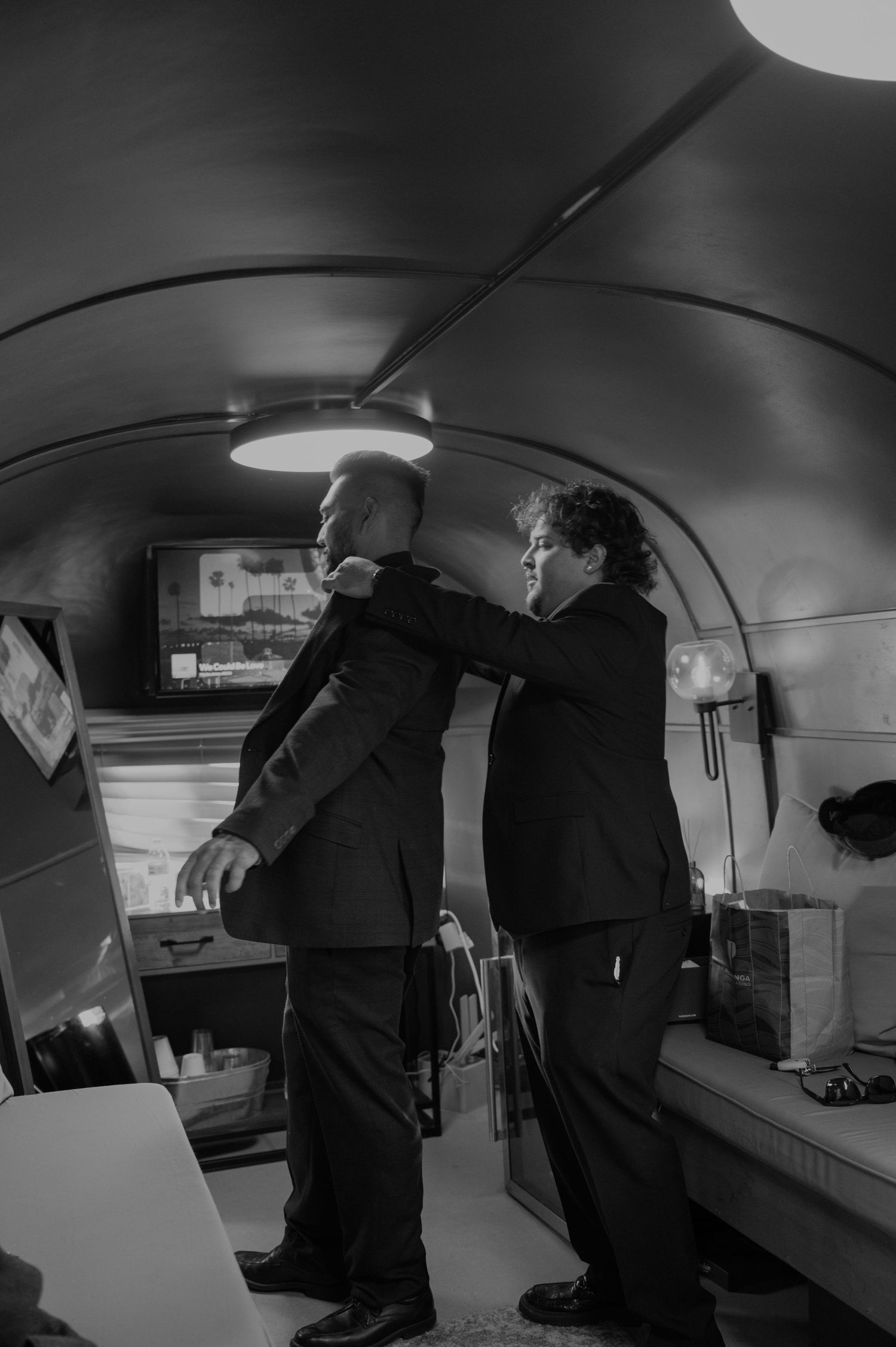 Black and white interior shots of people moving through a dimly lit curved space.