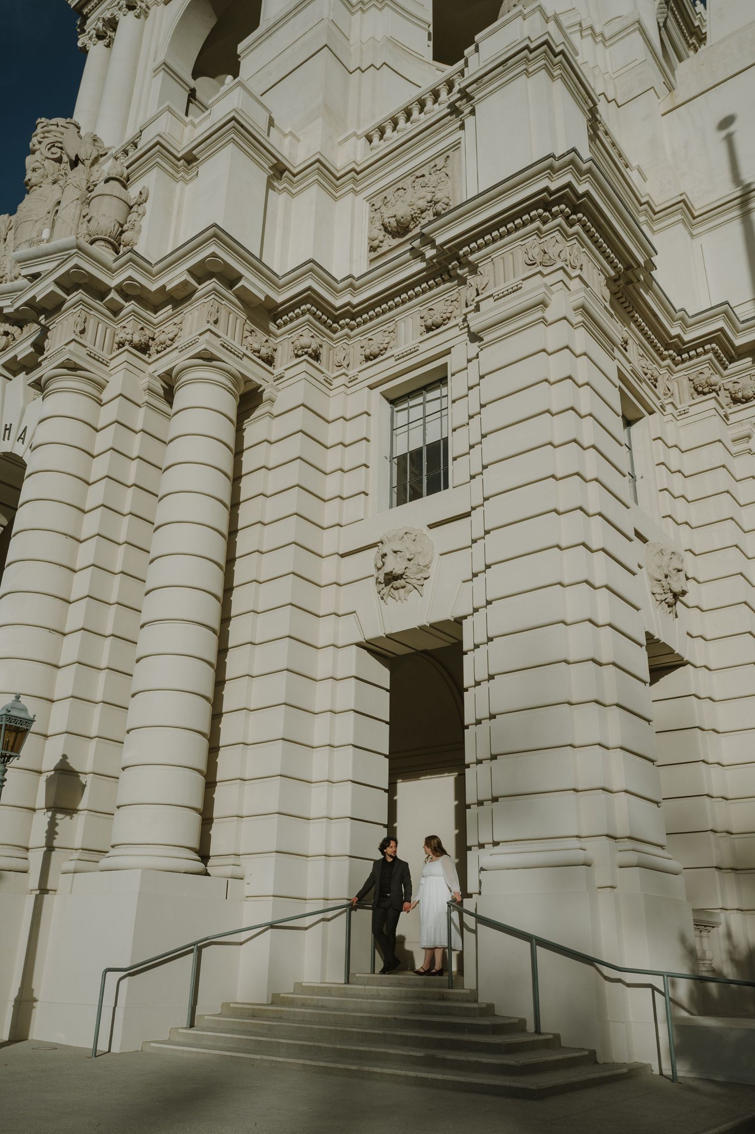 Grand white stone facade of historic building with ornate architectural details.