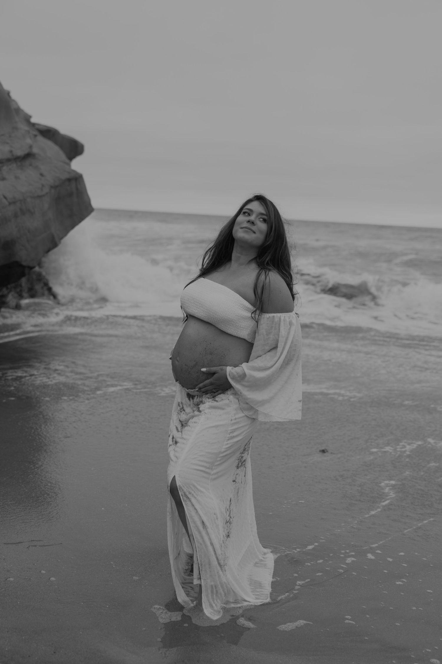 Ethereal black and white maternity portraits by the ocean.