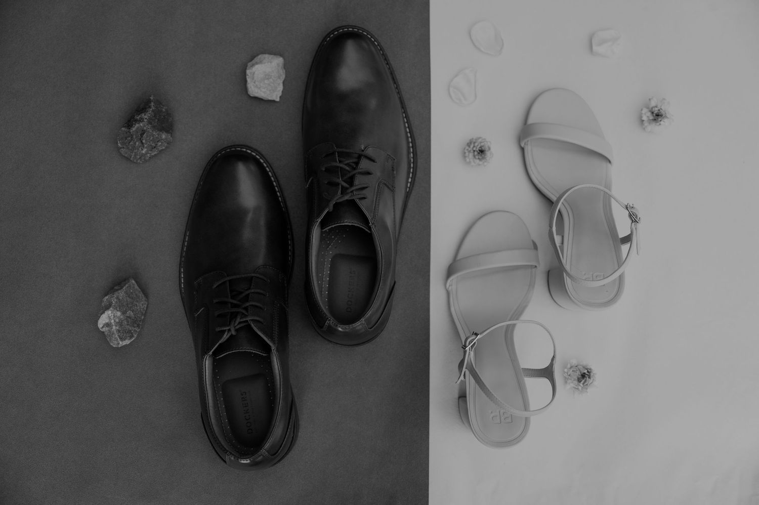 Black and white formal dress shoes arranged on a light background.