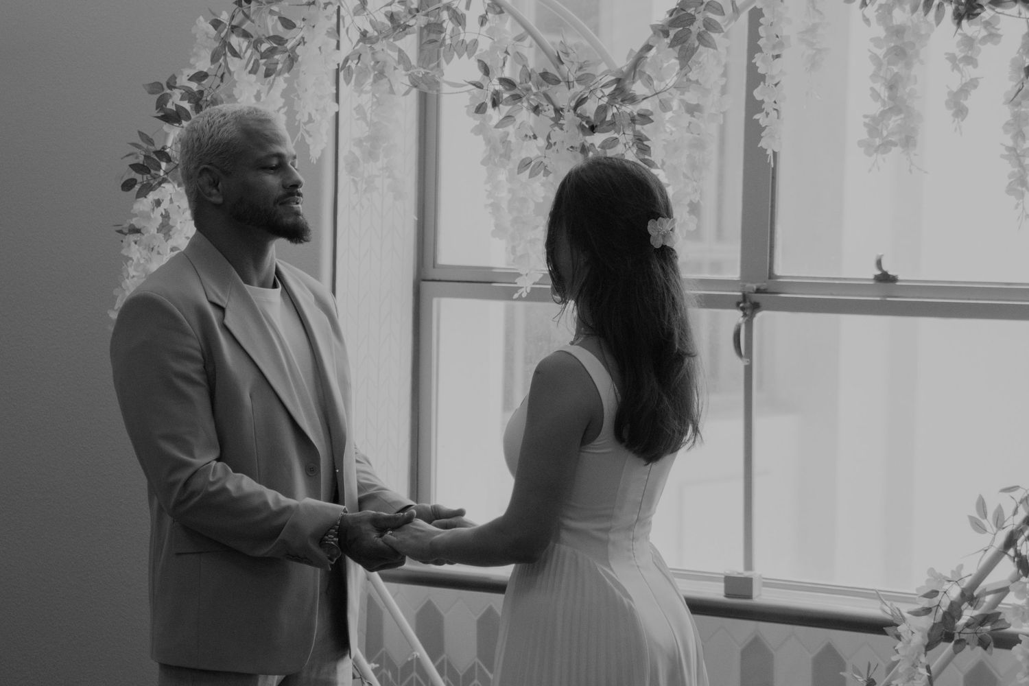 Couple dancing and twirling together in an elegant indoor setting.