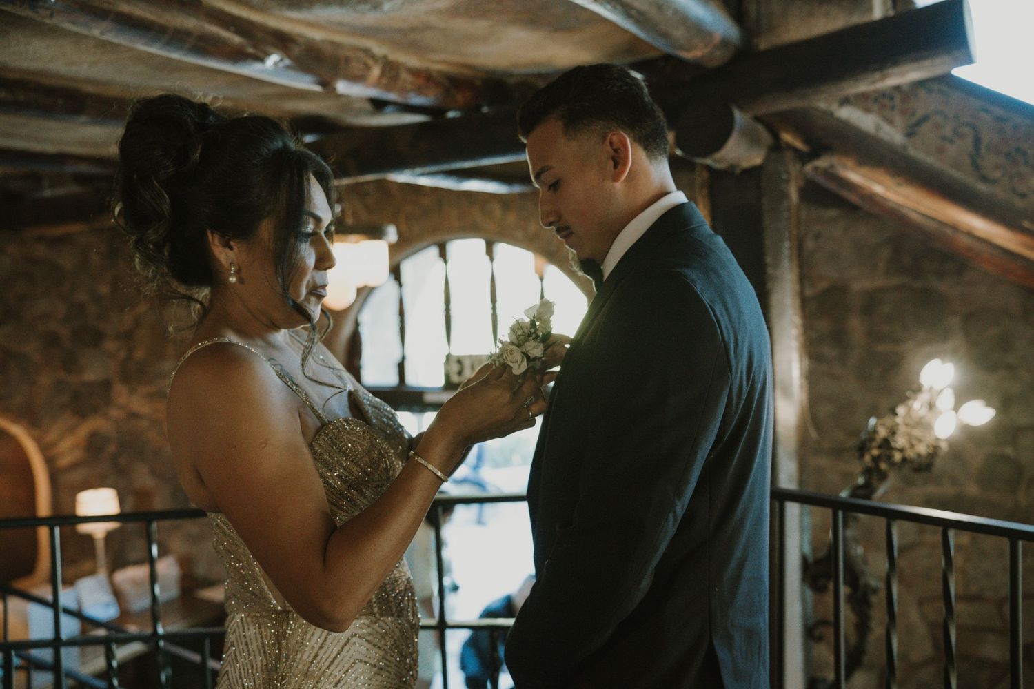 Intimate moments captured in a dimly lit rustic indoor setting.