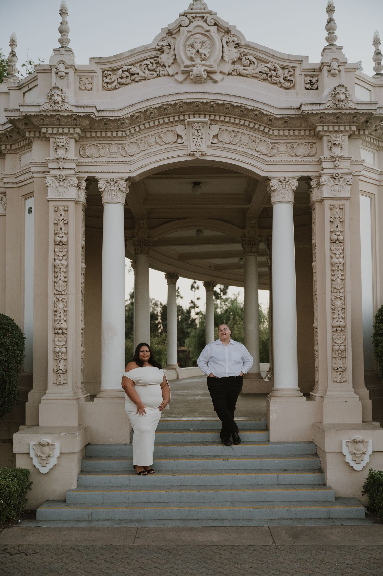Ornate white stone colonnade with decorative architectural details and columns.