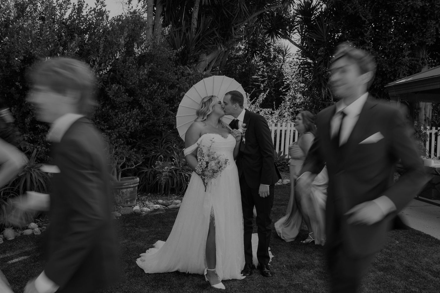 Vintage black and white wedding photo with motion blur of guests.