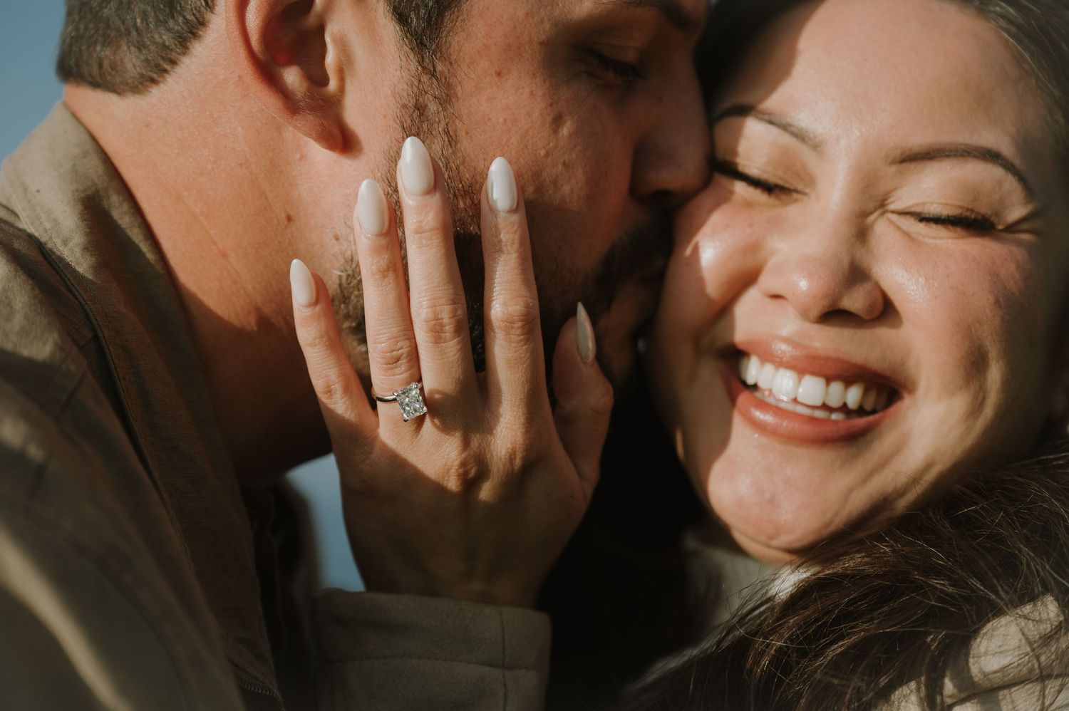 Close-up romantic portrait showing tender expressions and warm lighting.