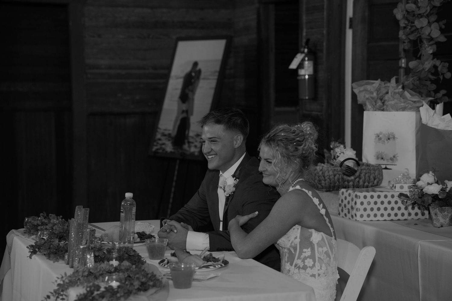 Dark reception hall with wedding guests enjoying the celebration.