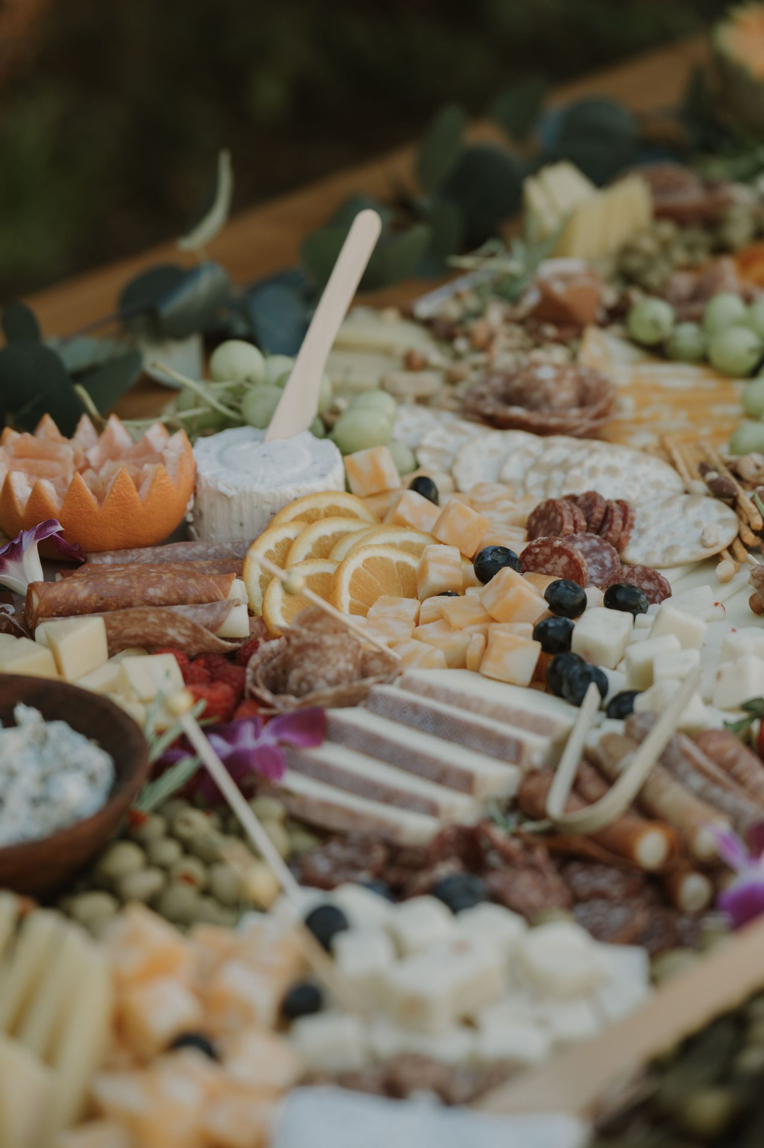 Elegant charcuterie board with assorted cheeses, cured meats, olives, grapes, nuts, and crackers for entertaining.