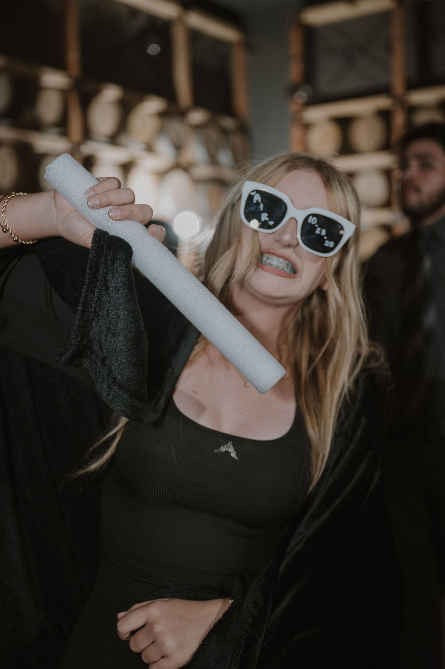 Party guest in sunglasses enjoying celebration at winery venue.