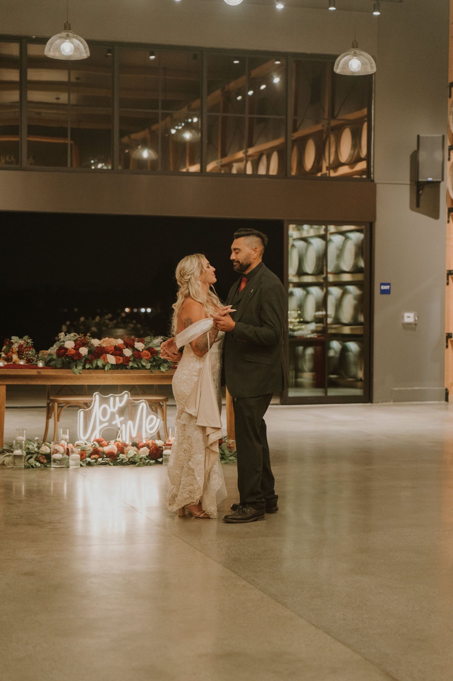 Modern industrial wedding venue with romantic lighting and floral decor.