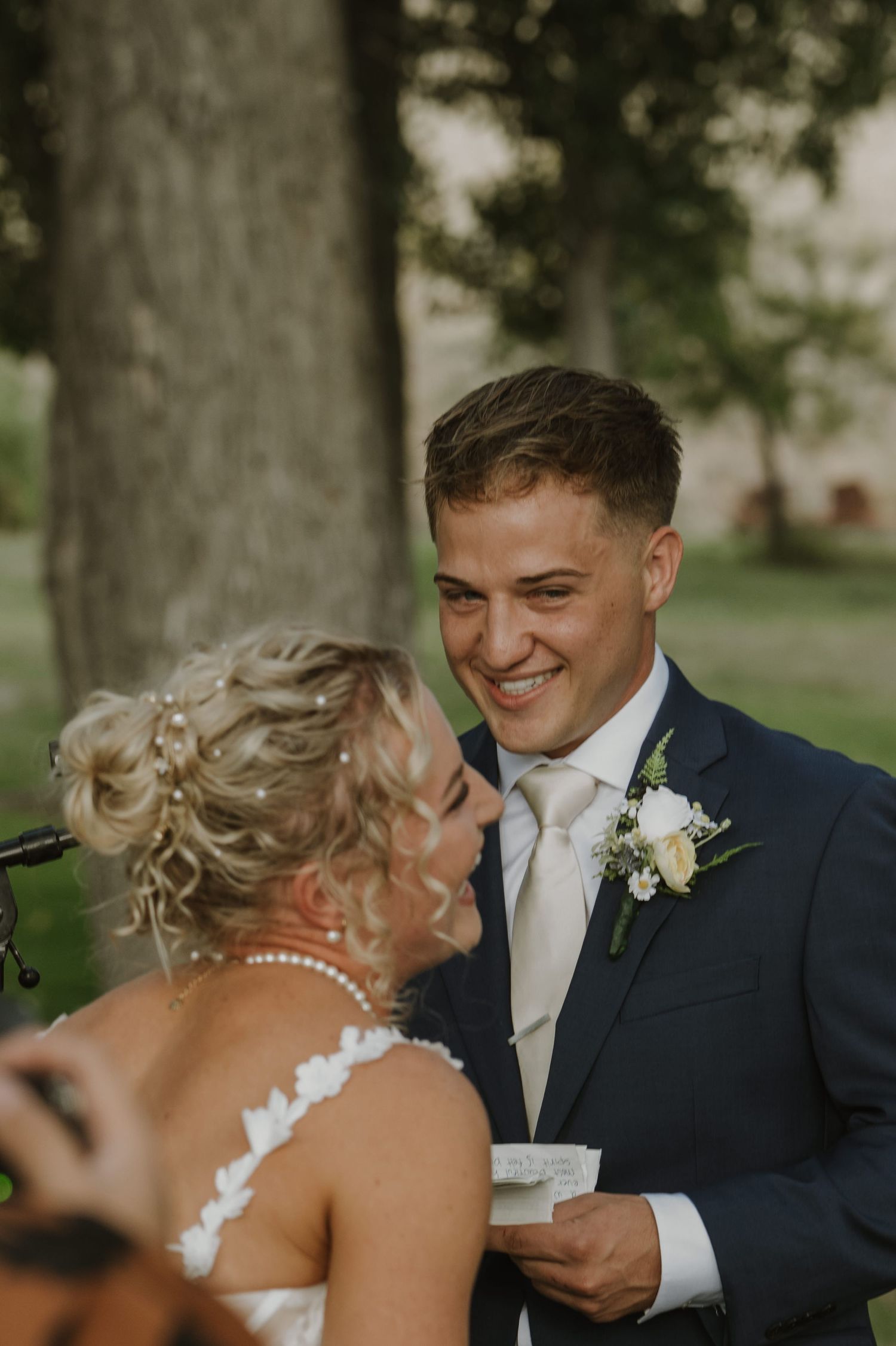 A romantic wedding moment captured between the couple during their outdoor ceremony.