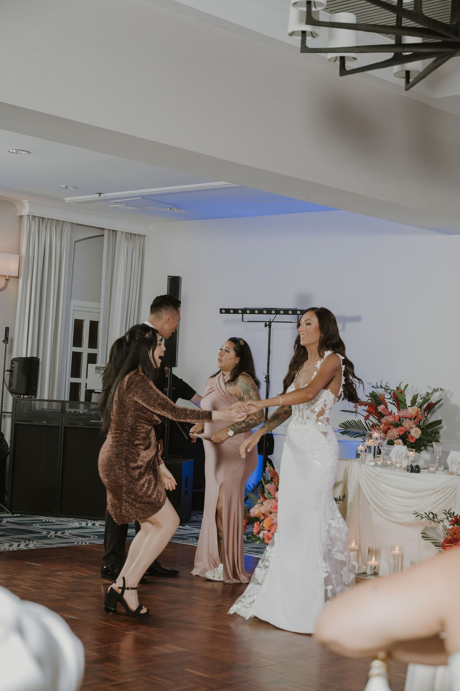 Wedding reception dance floor filled with guests enjoying celebratory moments.