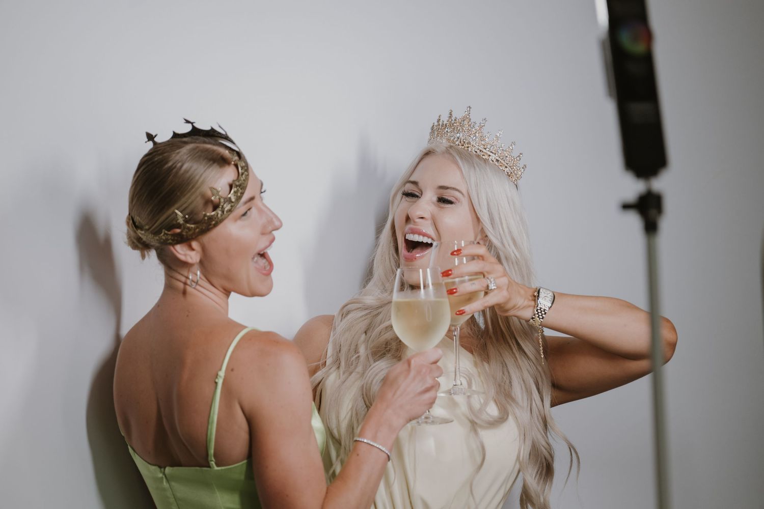 Wedding party members laughing and celebrating during a festive moment.
