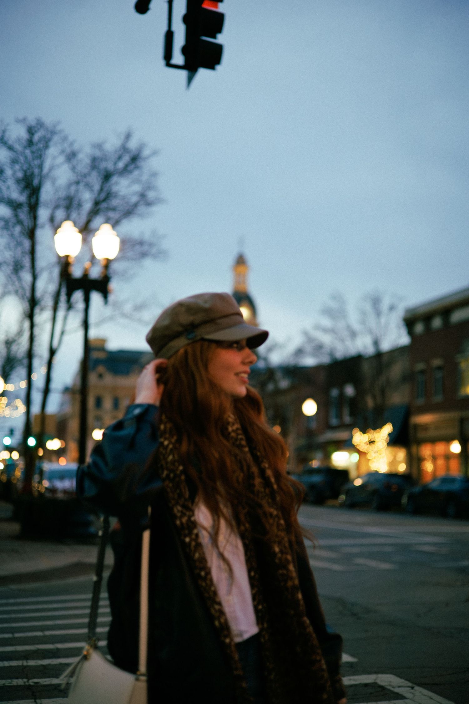Evening street photography with city lights and casual urban fashion.