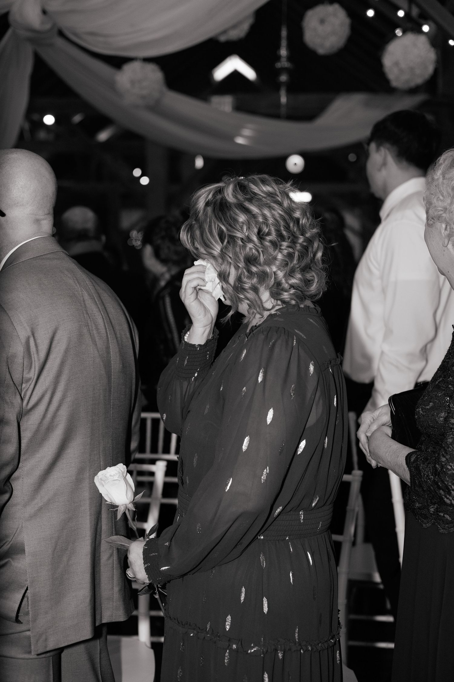 Wedding guests dancing in formal attire at an evening reception.
