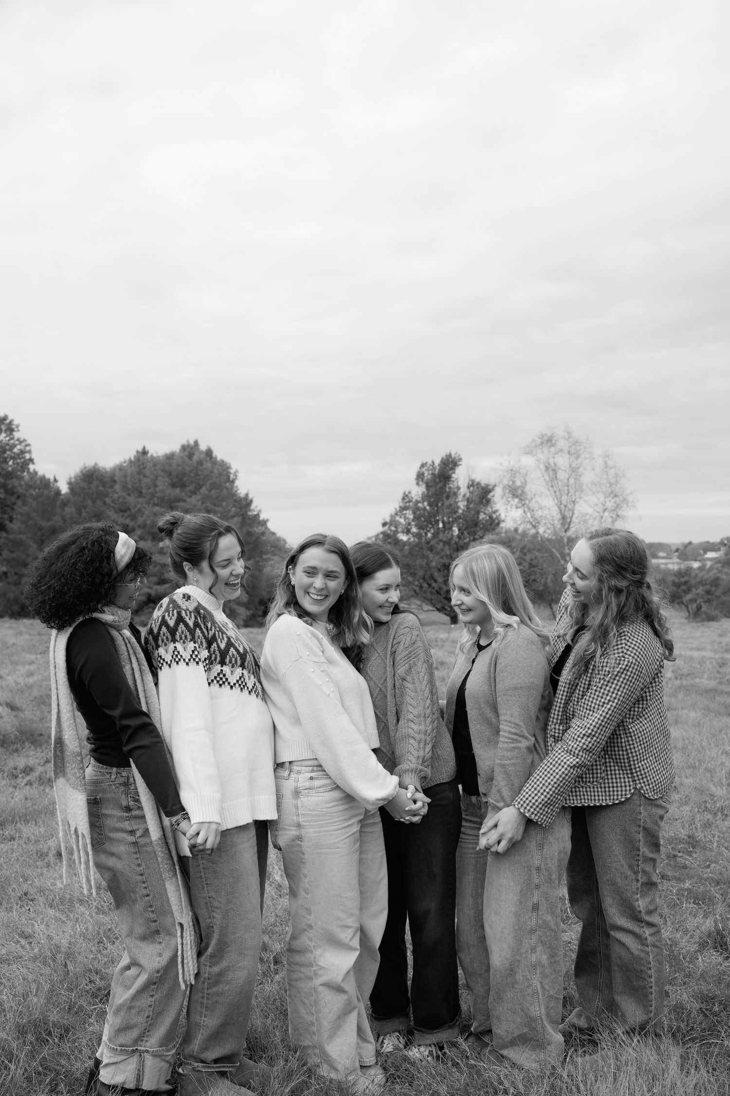 Vintage black and white photo of people lined up and leaning forward in a playful pose outdoors in Ohio.