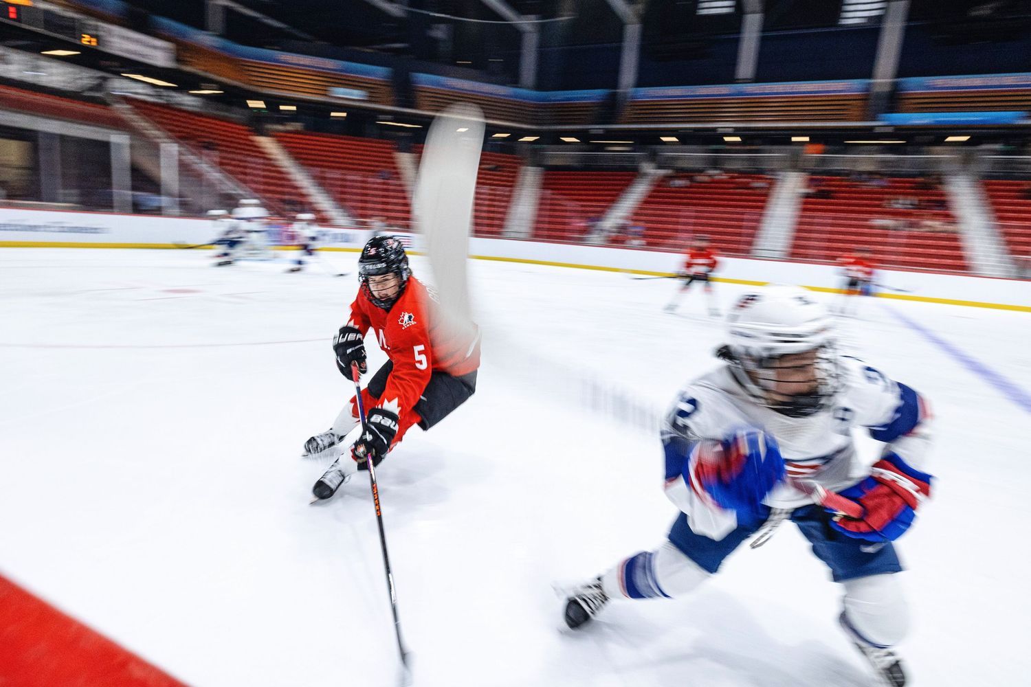 Hockey players chase after the puck during an intense NHL game between Montreal and Philadelphia.
