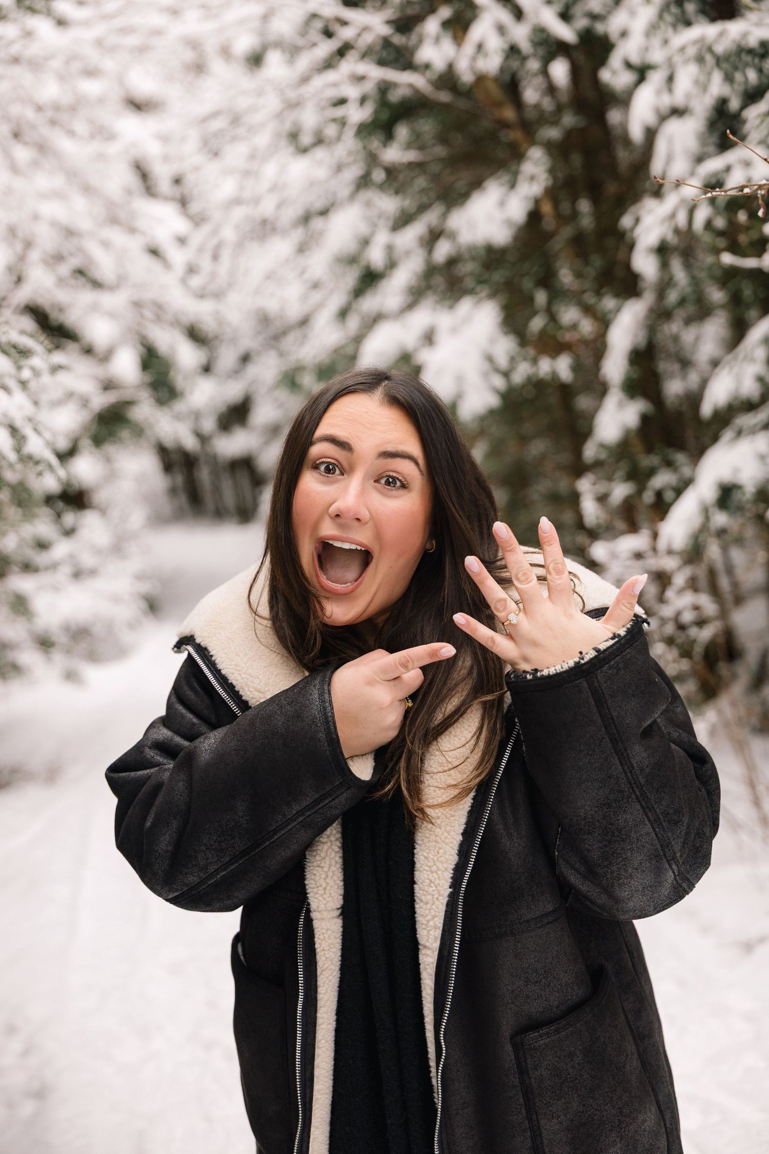 A joyful reaction in a snowy winter setting showing off a new ring.