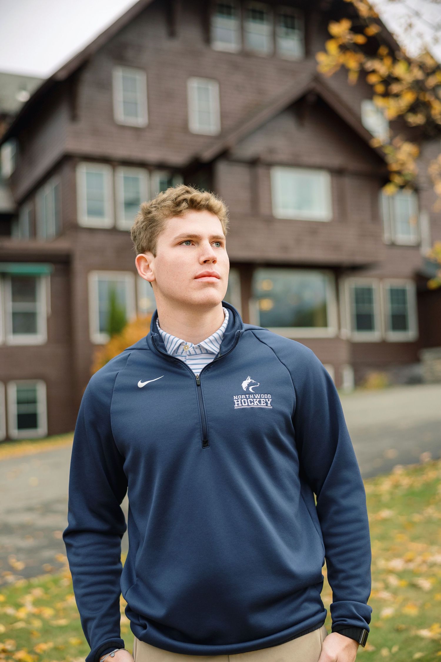 A series of outdoor portraits showing someone wearing a navy blue Nike athletic pullover against a backdrop of autumn trees.