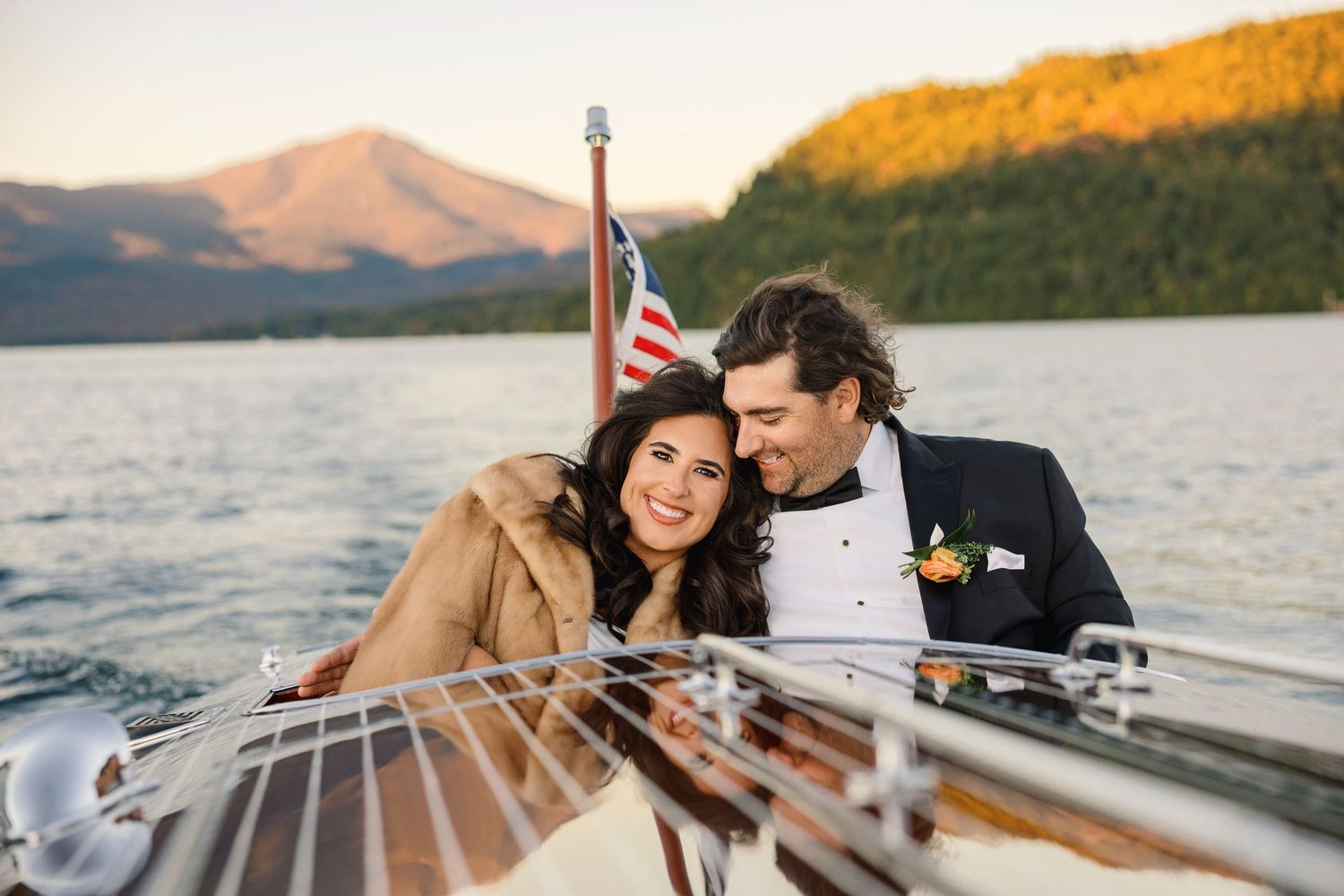 A romantic couple shares intimate moments on a boat dock during a lakeside sunset photo session.