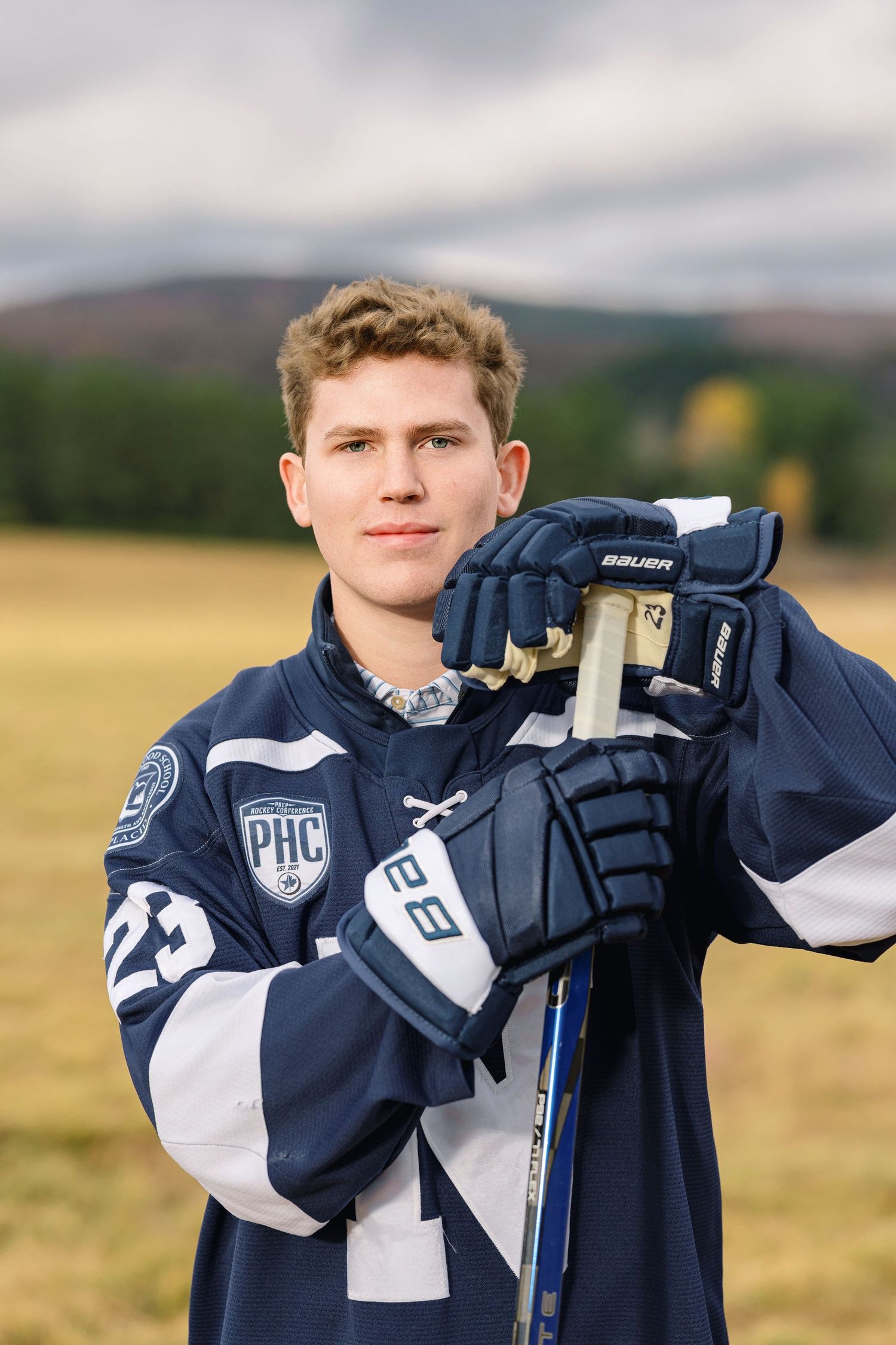 A series of cropped photos showing a person in a navy blue and white sports uniform posing in an outdoor field setting.