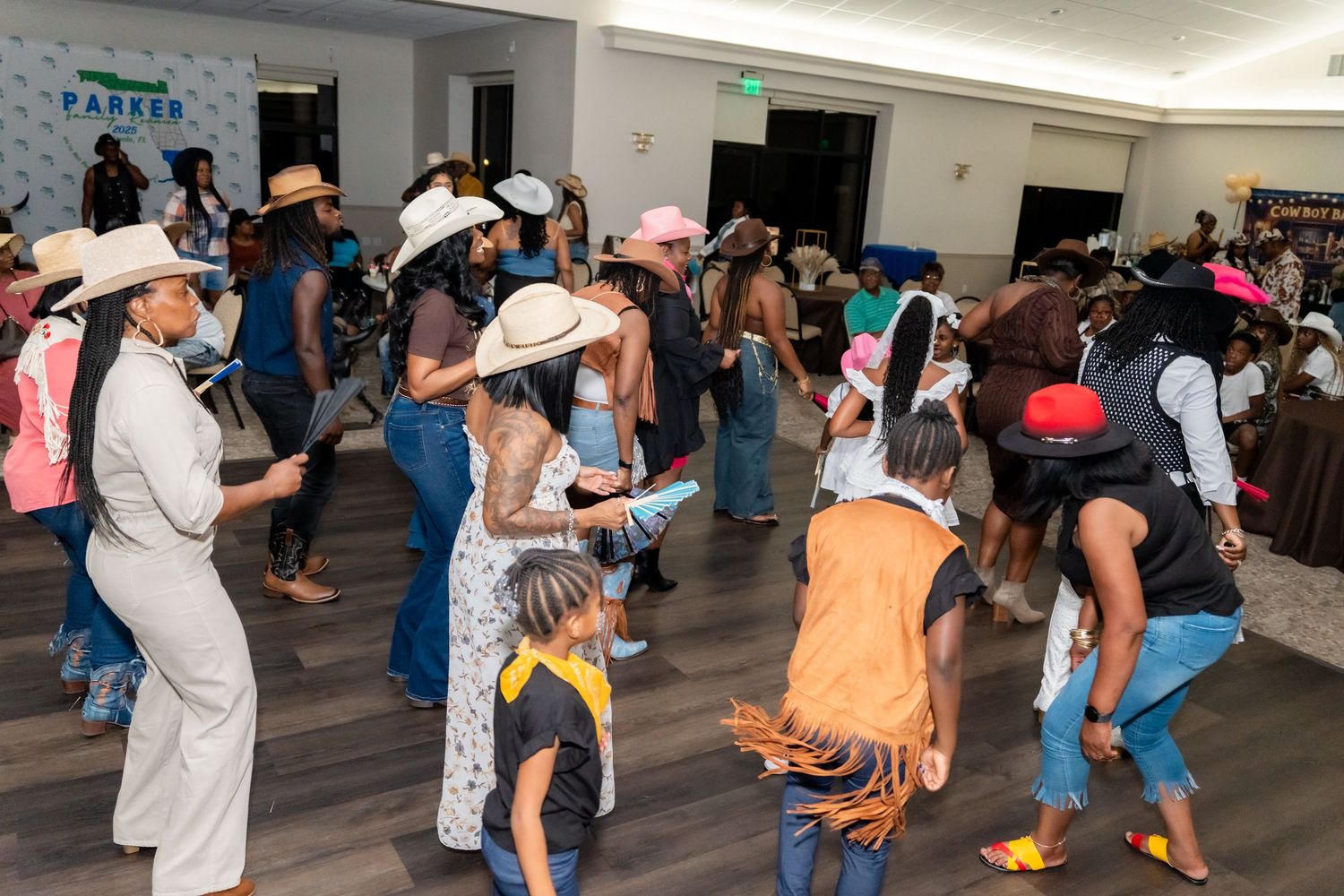 People dancing together in pairs on a wooden floor during a social dance event in an indoor venue.