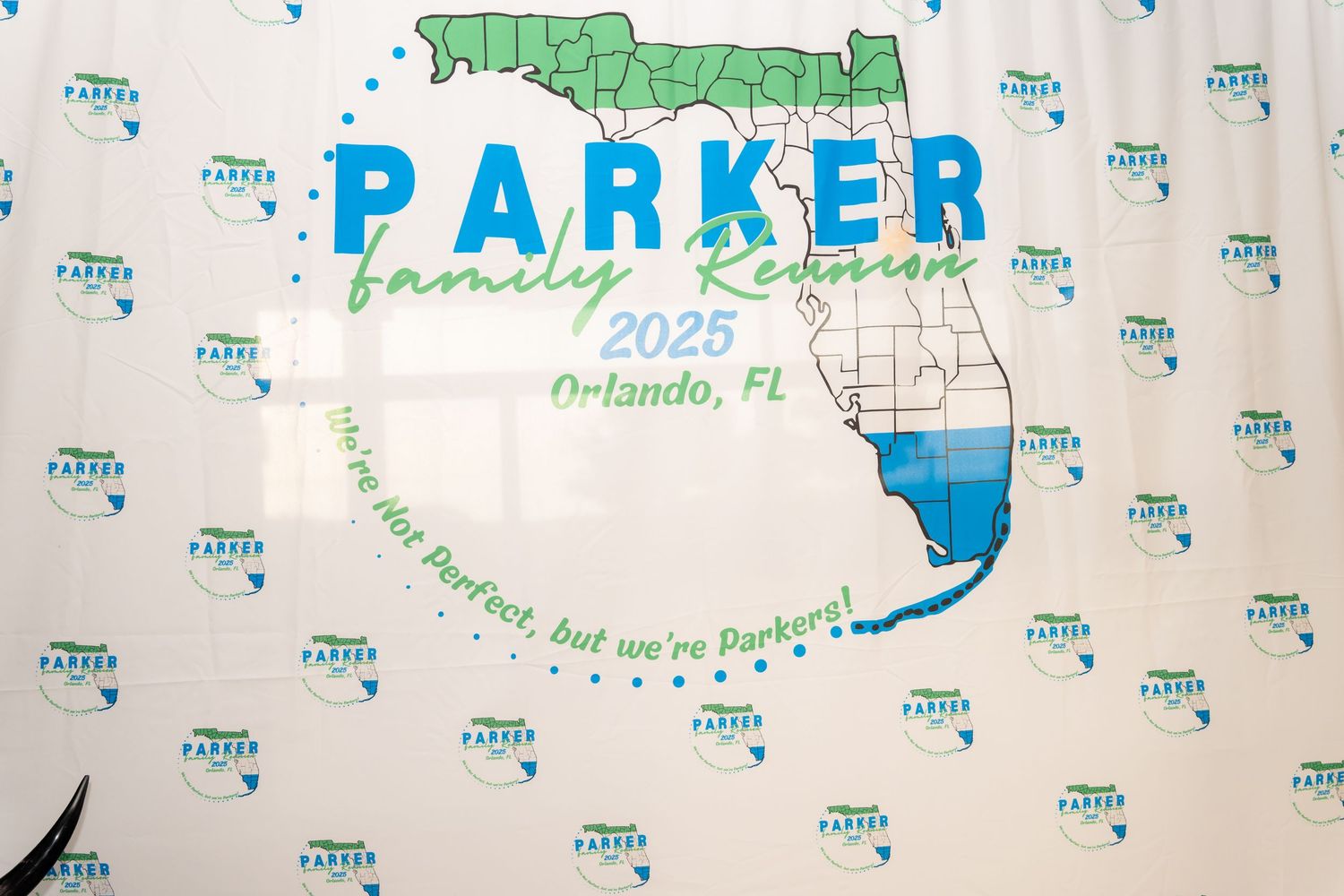 A large blue text sign spelling out PARKER mounted on a light colored wall with decorative elements.