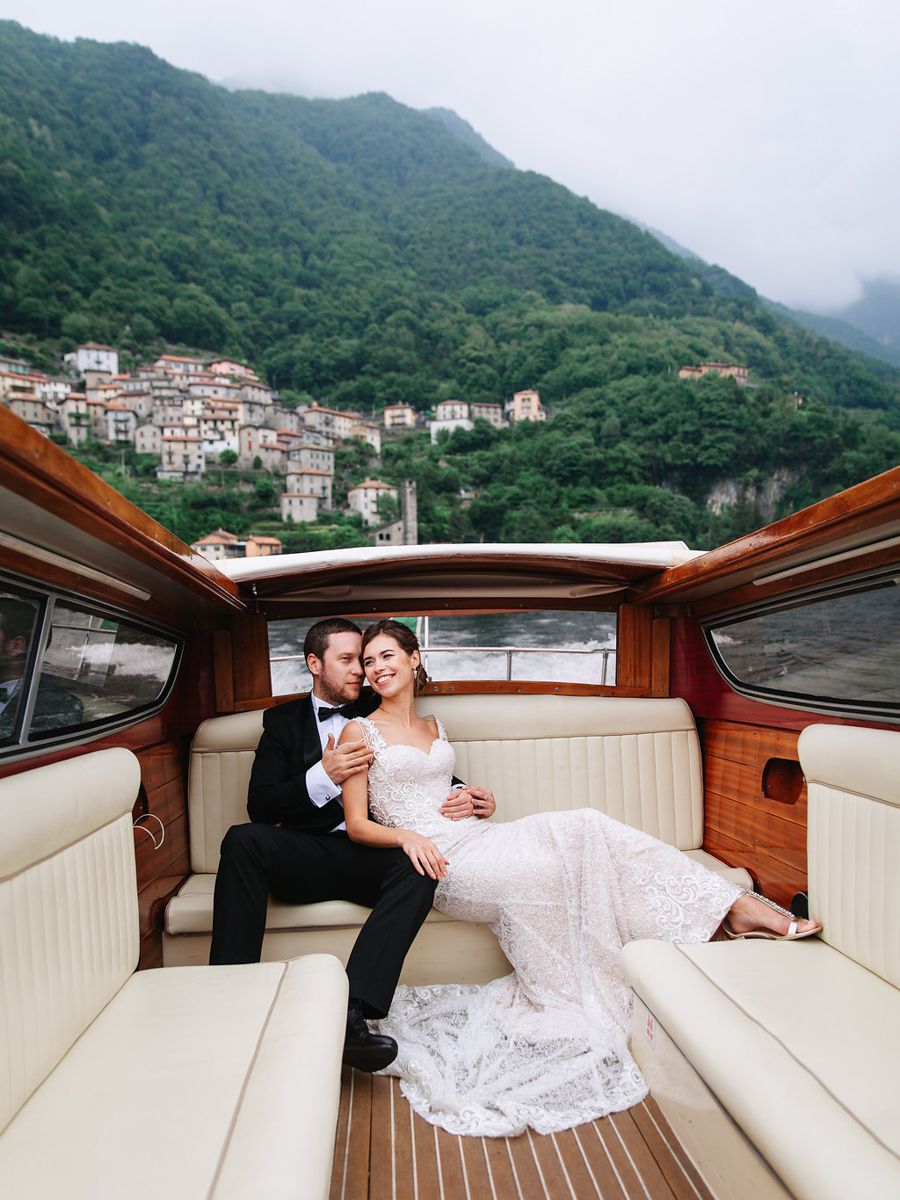 A romantic boat ride along the coast with mountains and a hillside village in Hong Kong creating a scenic backdrop.