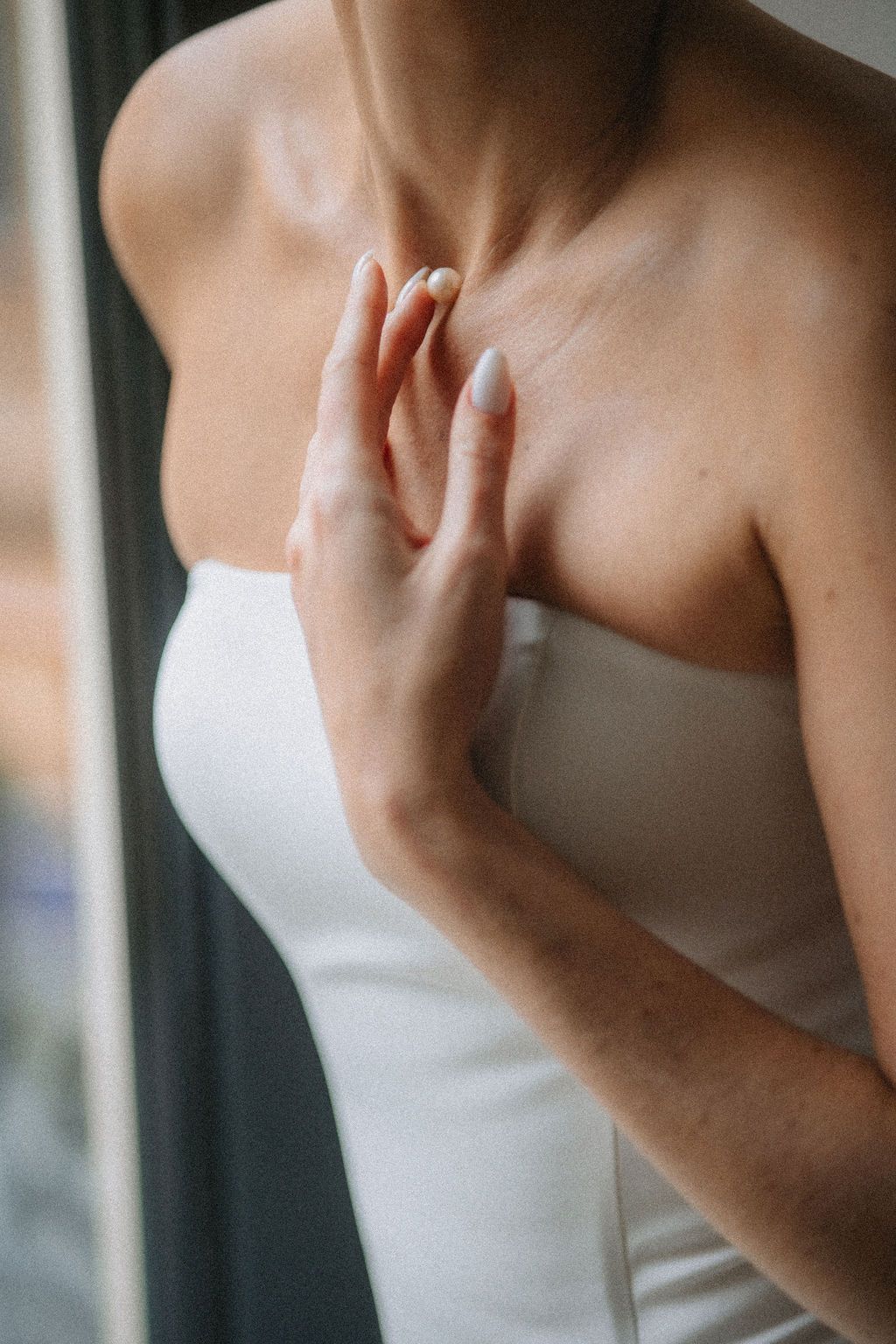 Close-up details of a strapless white wedding dress bodice shown in a series of cropped shots.