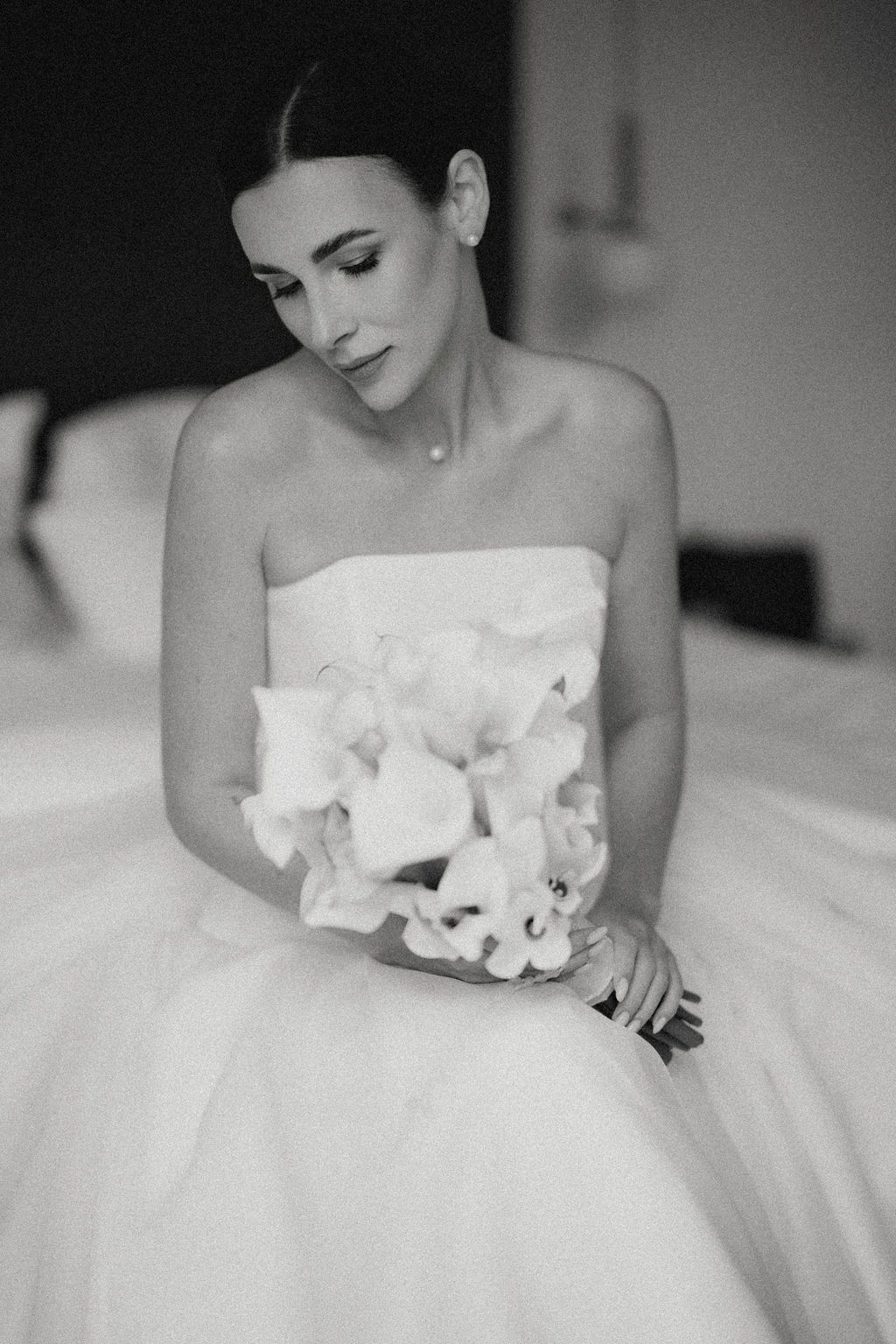 Black and white bridal portraits showing elegant white wedding gown with strapless bodice and full tulle skirt.