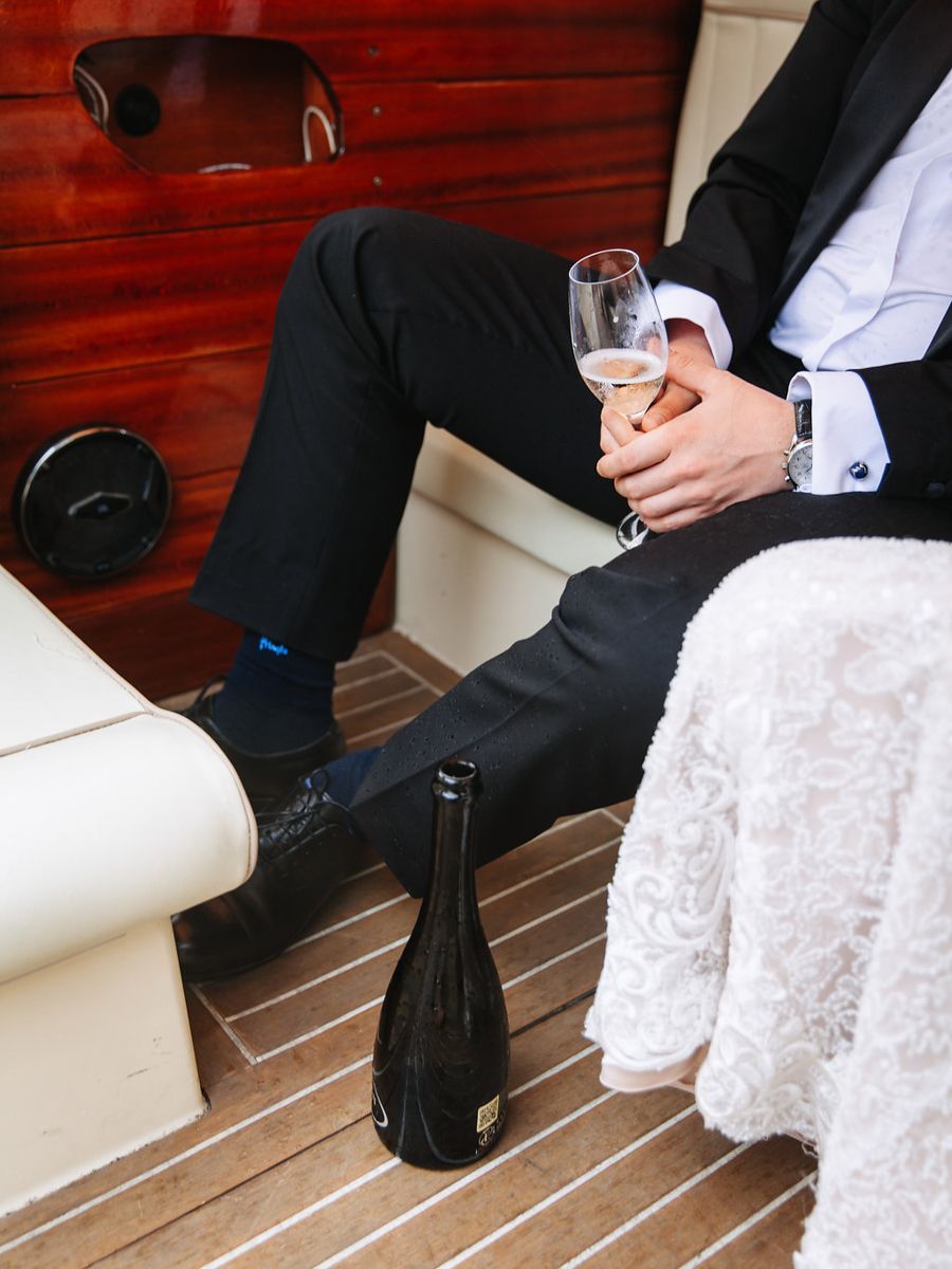 A row of formal shoes and dress clothing details shown in close-up shots against a wooden deck background.