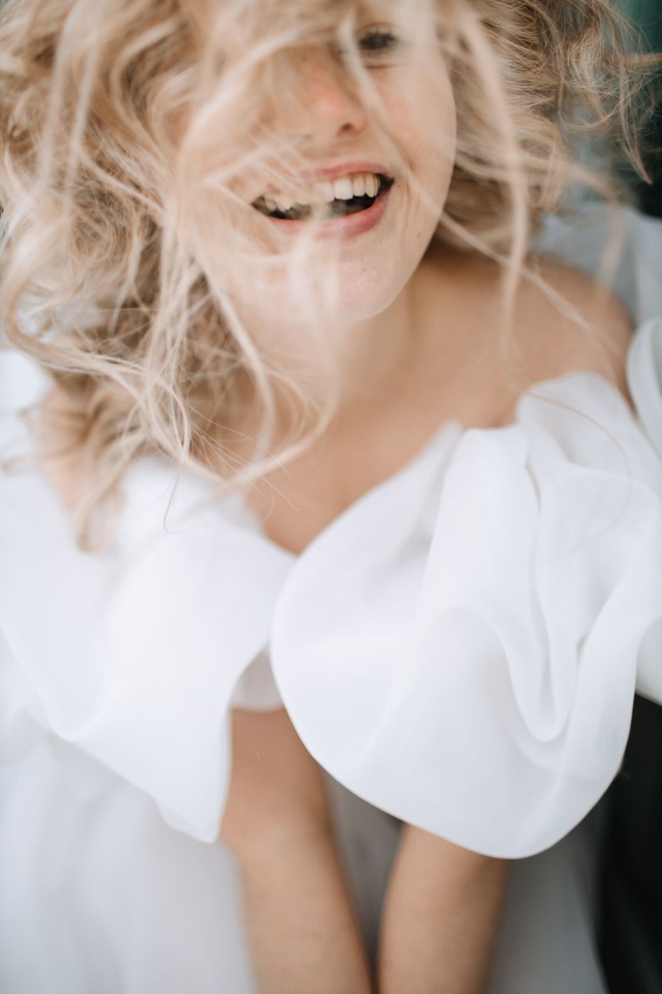 Close-up fashion portraits showing blonde hair and white clothing in soft focus.