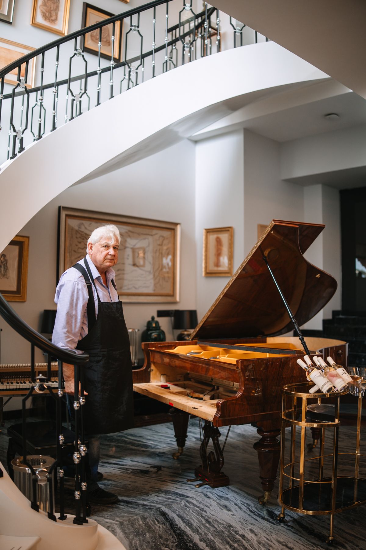A series of four connected images showing a grand piano in an elegant room with natural lighting from above.