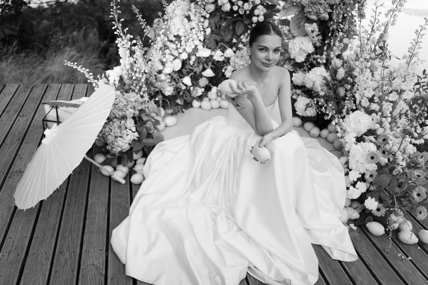 Black and white wedding photos showing couple in elegant attire posing together with floral decorations.