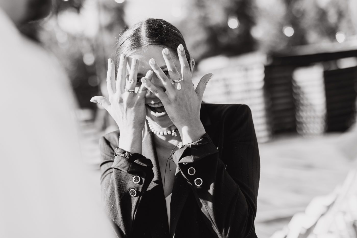 A black and white photo collage shows multiple candid laughing moments captured in a casual setting.