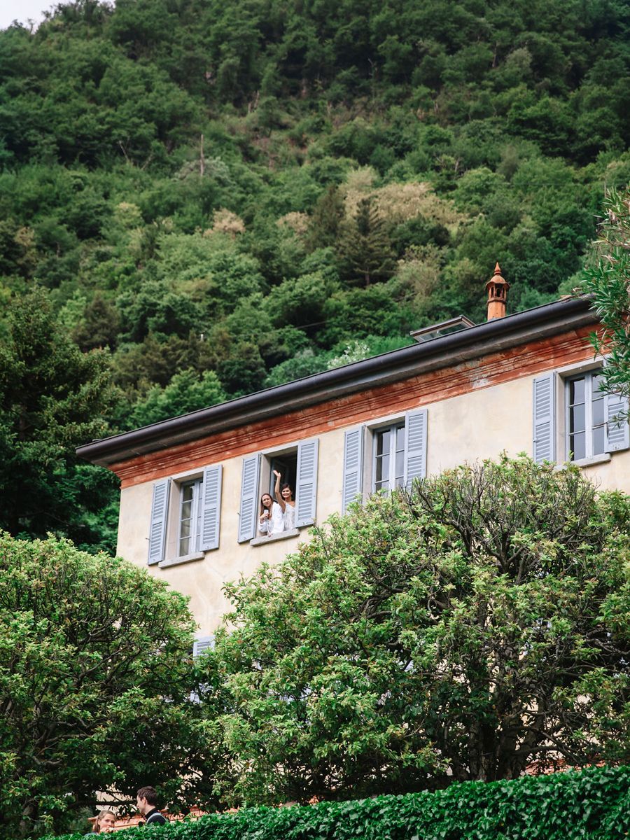 A series of panoramic photos showing a rustic house with blue shutters nestled against a lush green hillside.