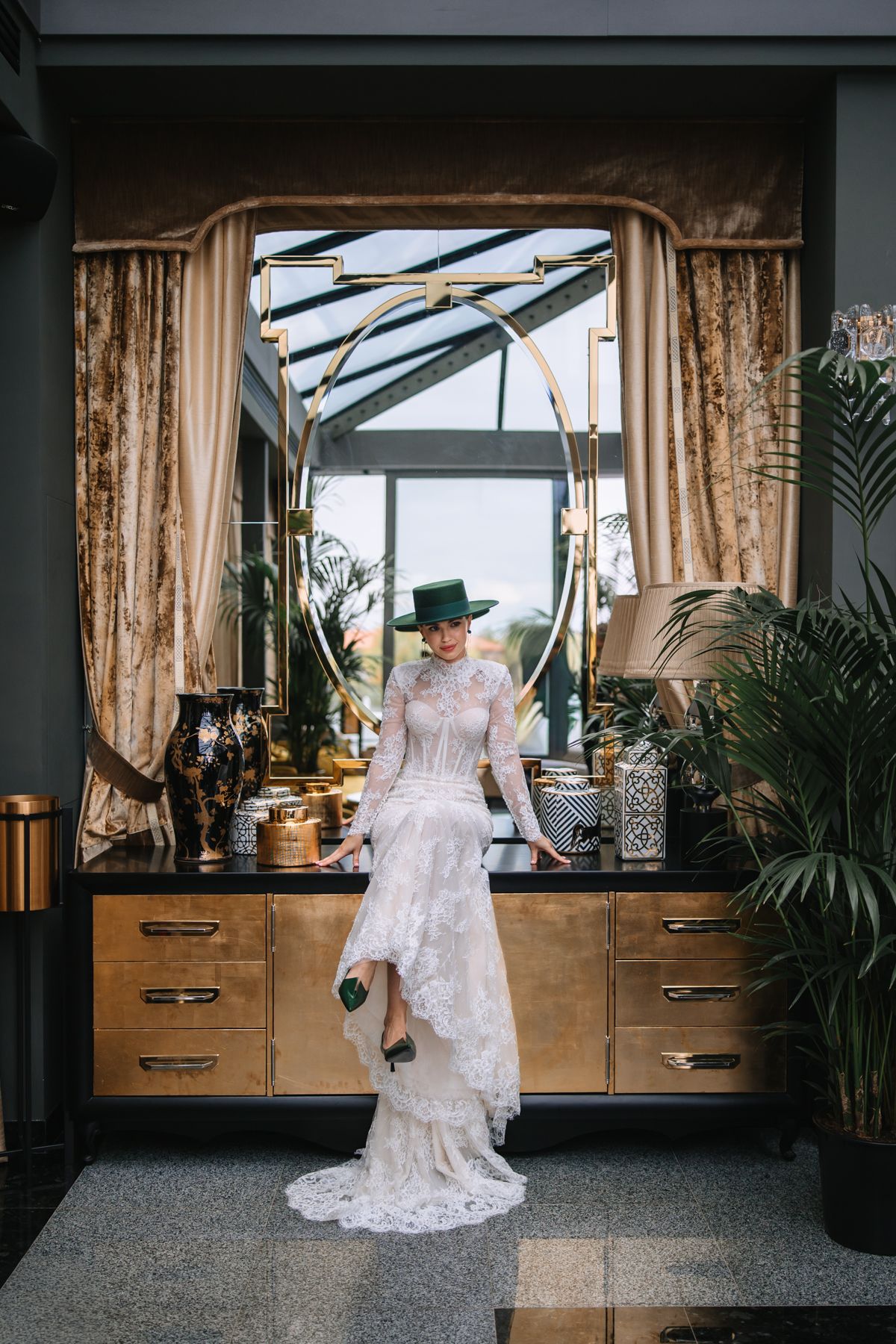 A series of five wedding dress photos showing the back details of a lace gown in front of large windows with natural light.