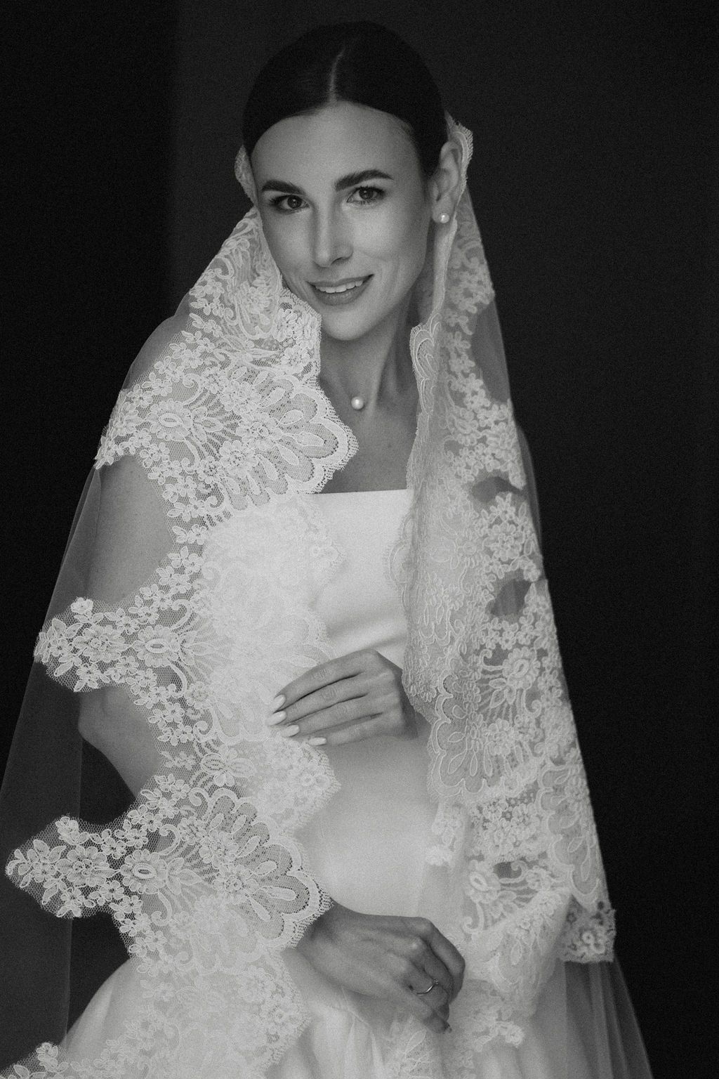 A series of black and white bridal portraits showing elegant lace veil details and wedding dress in dramatic lighting.