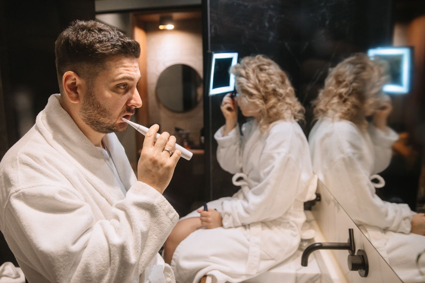 Candid moments in white robes during morning preparation.