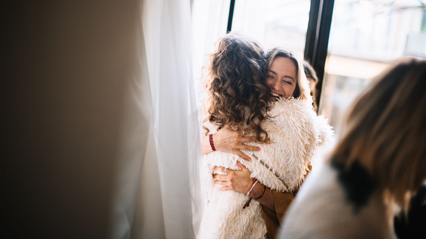 A couple embraces in a tender moment during their wedding day celebration.