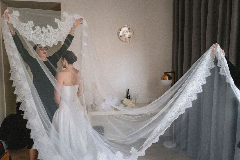 A bride in a flowing white wedding dress twirls gracefully, creating a beautiful circular motion with the fabric.