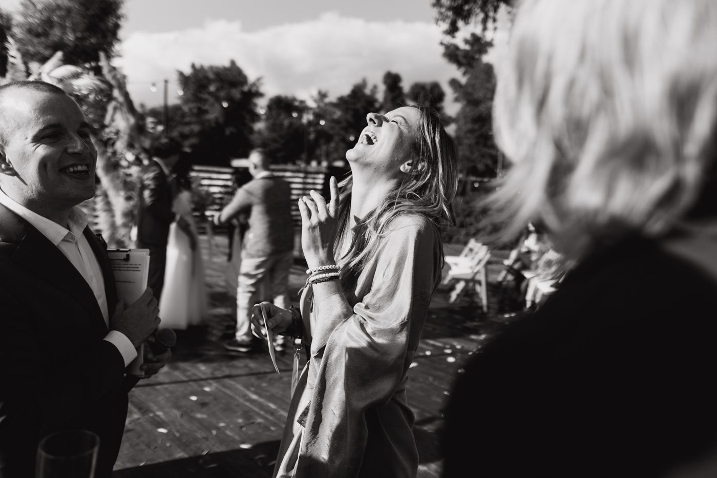 Black and white film photos show people dancing and celebrating at an outdoor party or gathering.