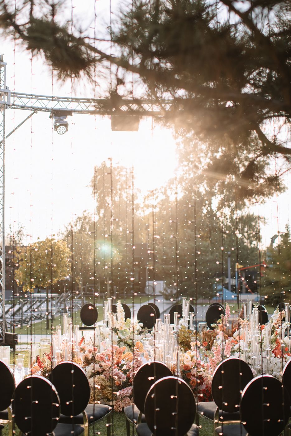 Outdoor event venue at sunset with string lights creating a magical atmosphere.