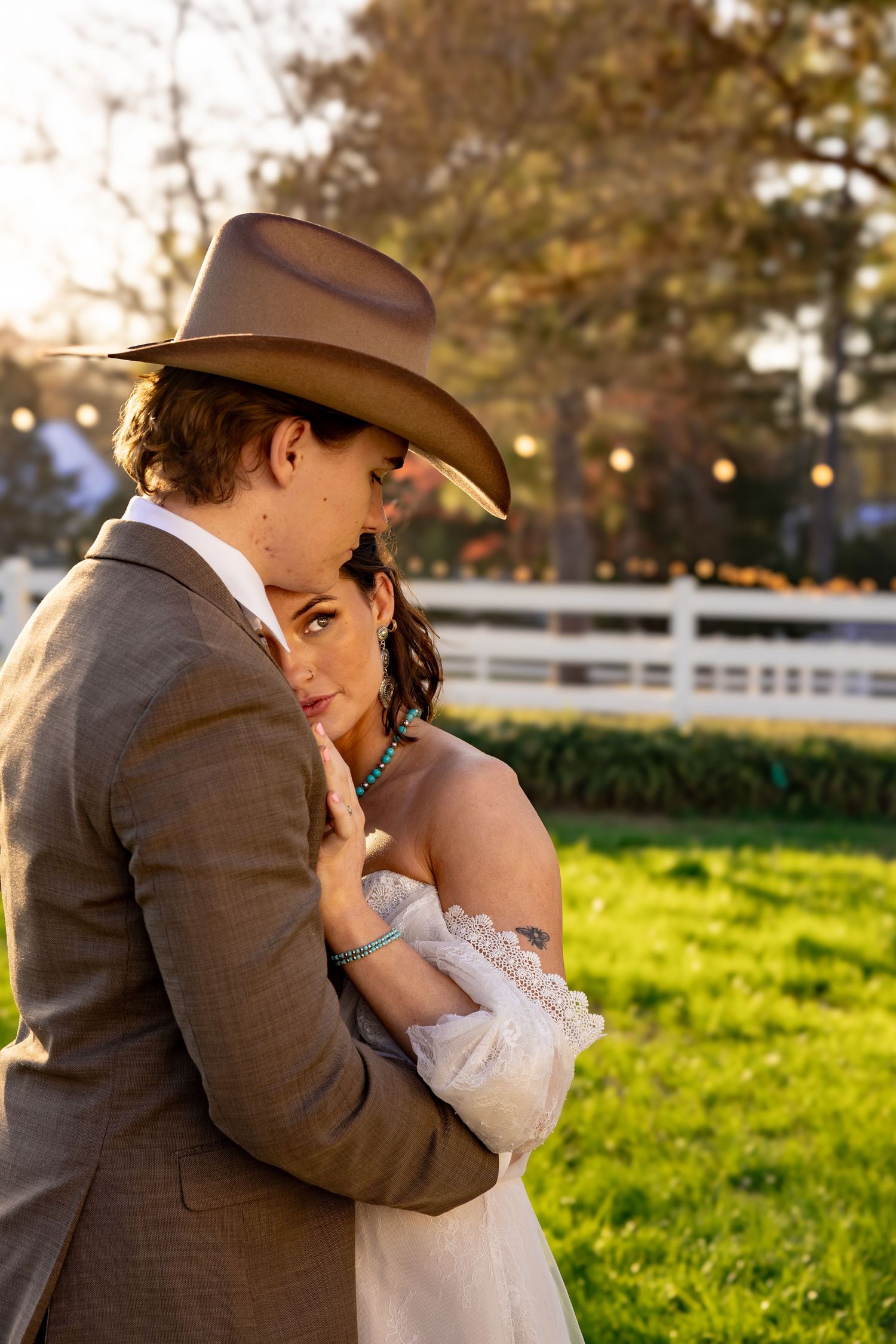 Romantic sunset wedding portraits in a rustic setting with golden afternoon light.