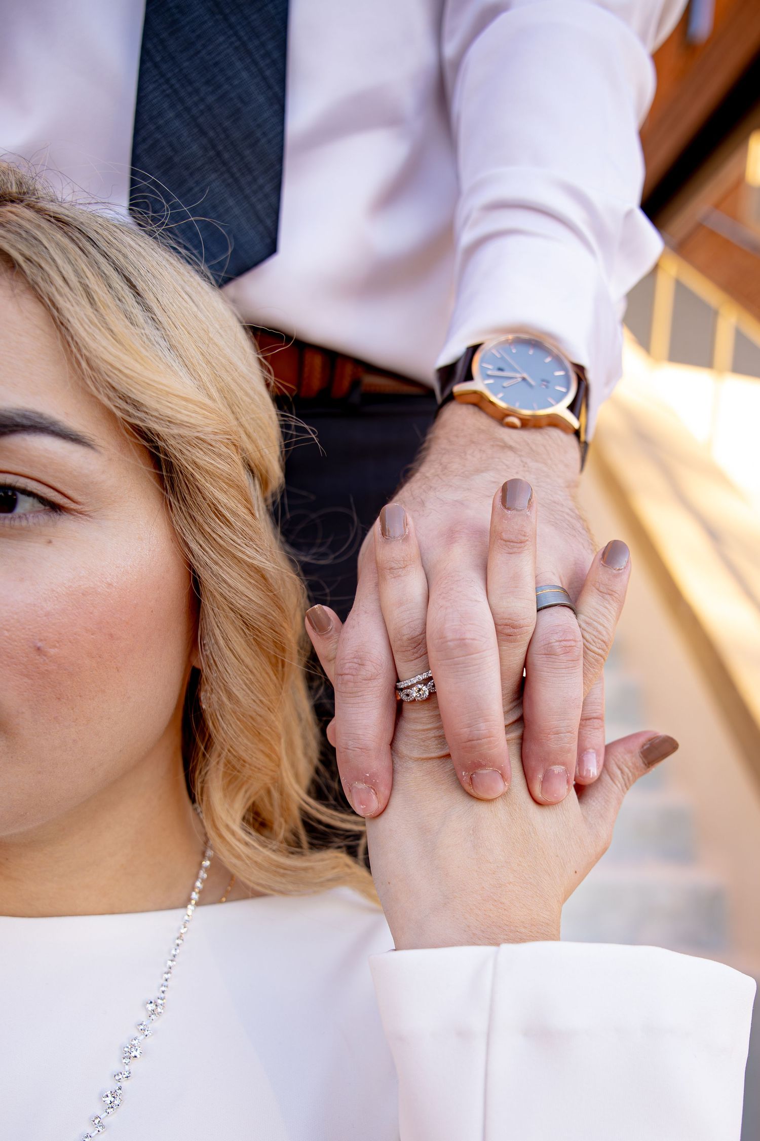Close-up detail shots of wedding rings and hands during an intimate moment.