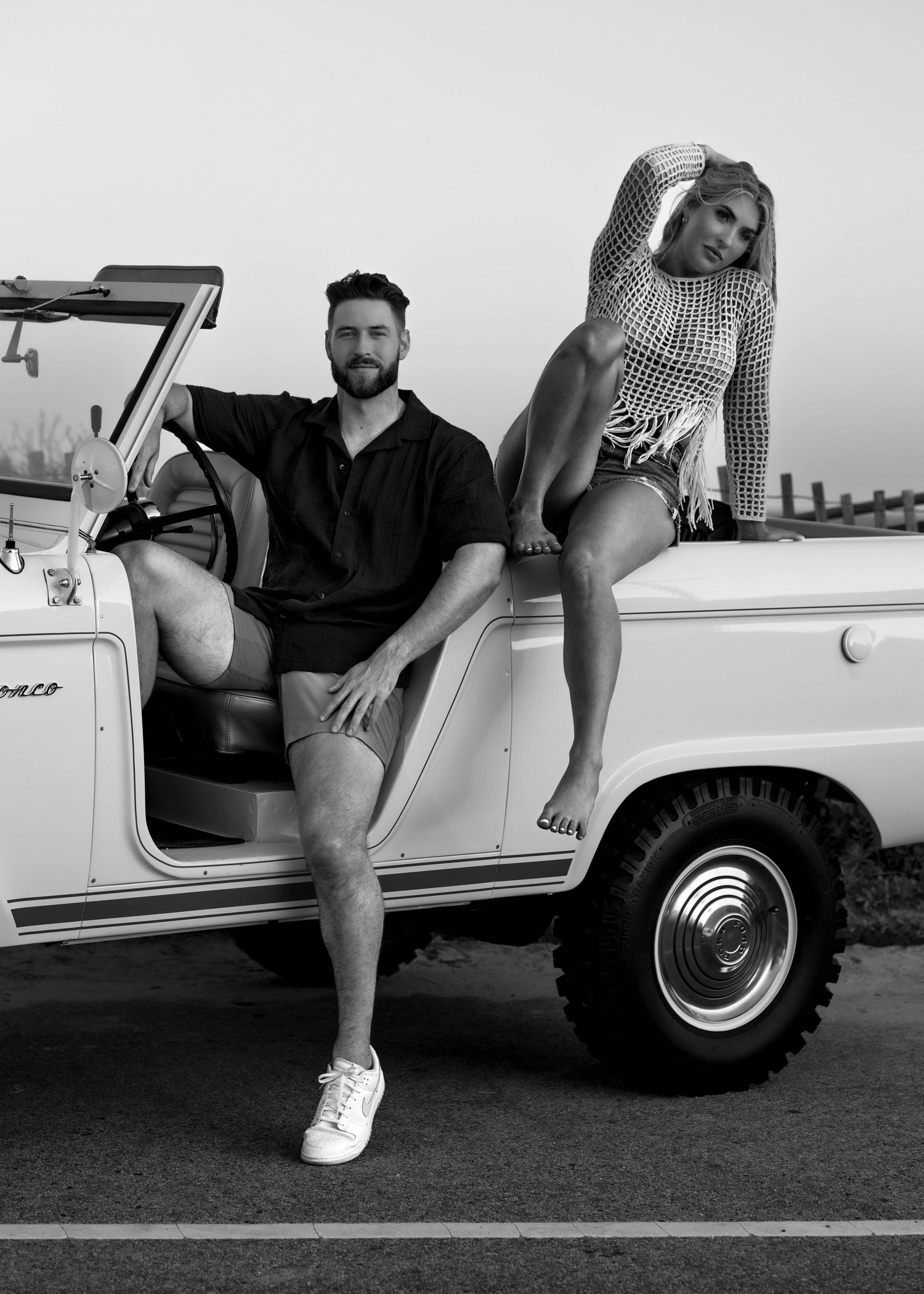 Black and white photos of couple posing with classic white vintage car.