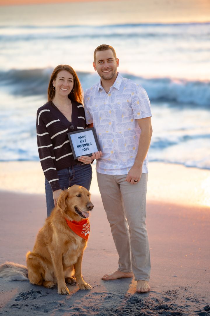 Beach photoshoot featuring a couple with their golden retriever at sunset.