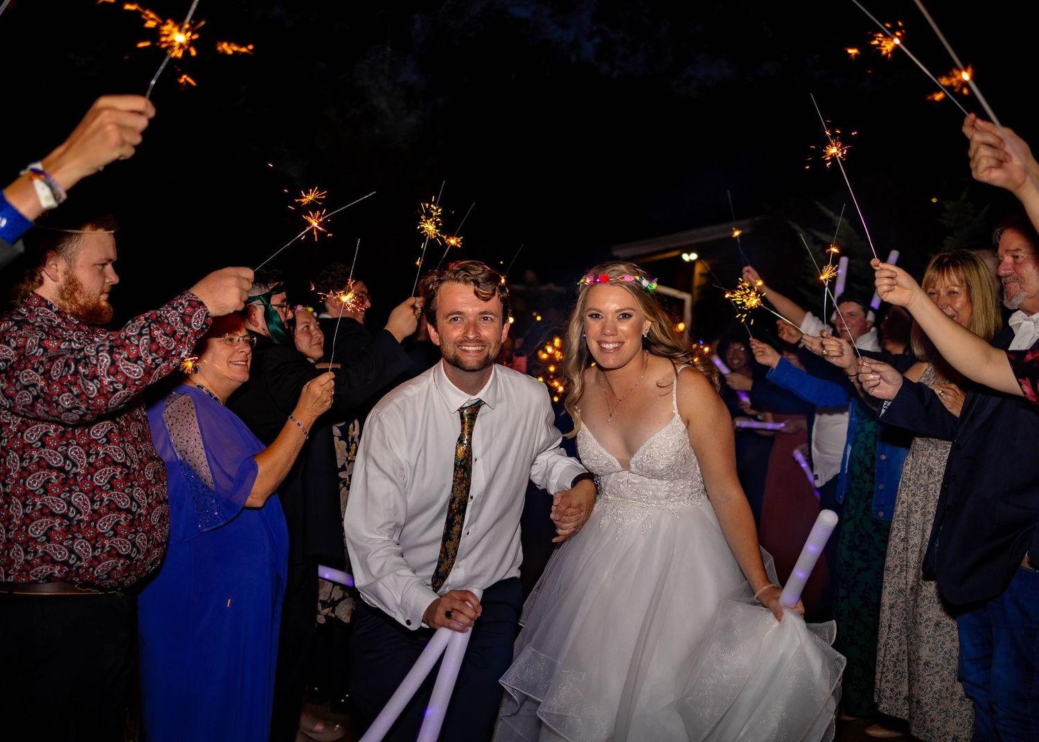Wedding reception celebration with sparklers creating a magical nighttime atmosphere.