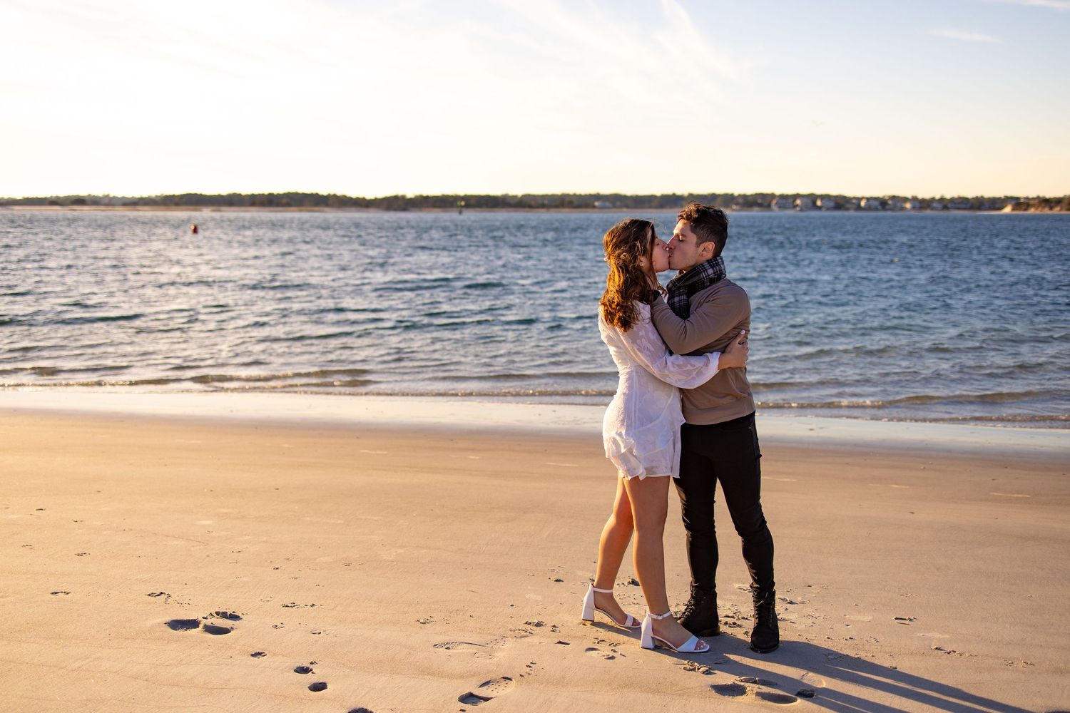 Beach proposal sequence captured during golden hour with ocean backdrop.